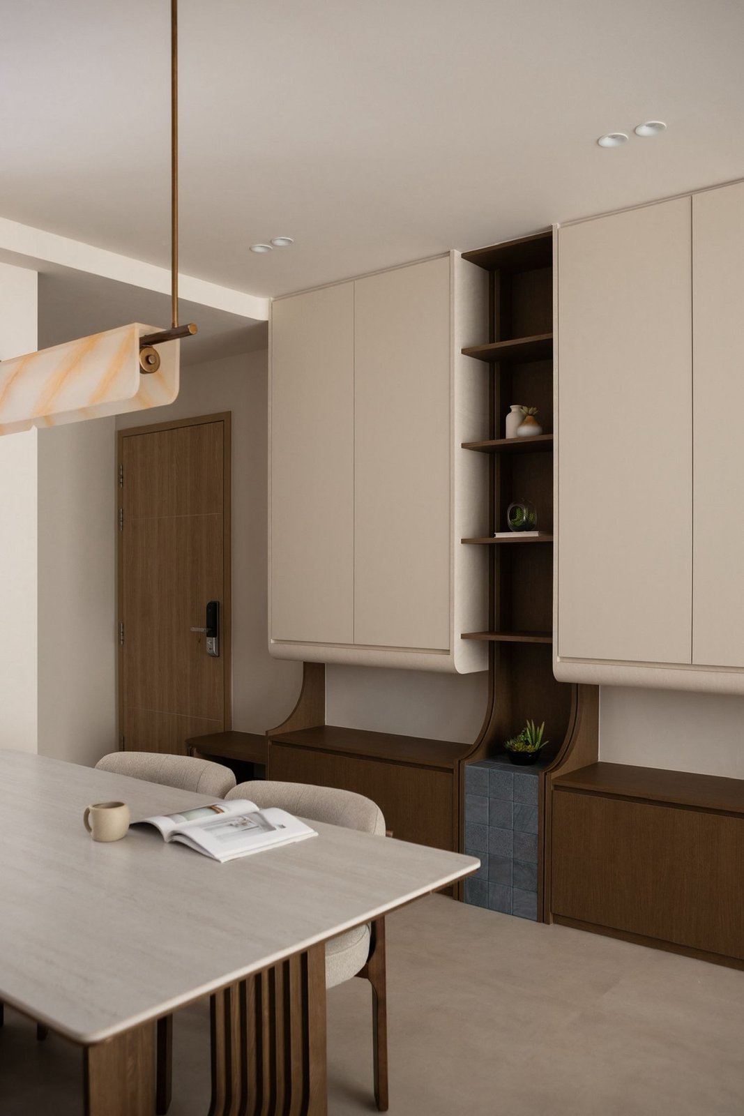 A warm, minimalist dining area on seamless micro-cement-look Hana vinyl flooring